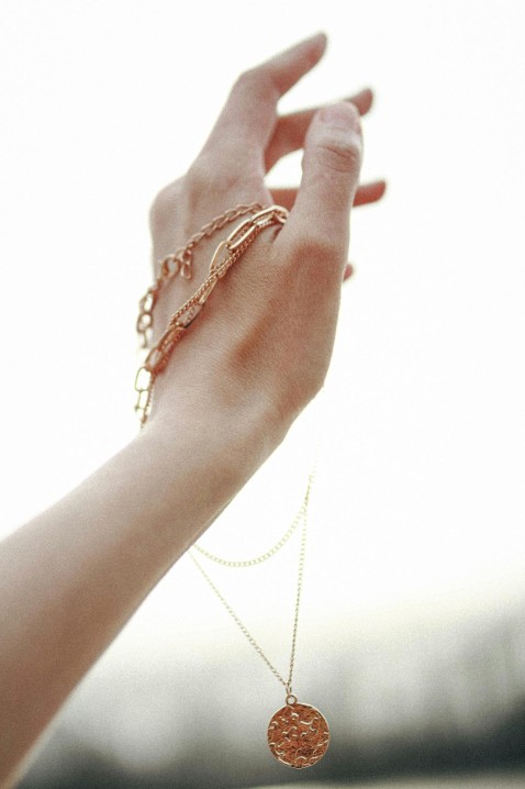 Handmade gold pendant on dark background